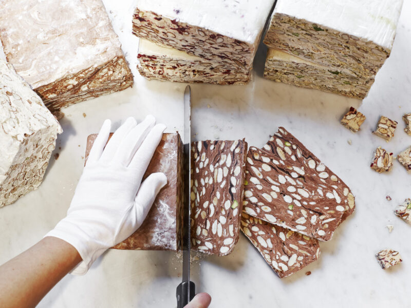 In this picture, the soft nougat is cut into slices and into cubes.